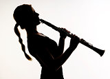 Female Musician in Silhouette Practices Woodwind Technique on Cl