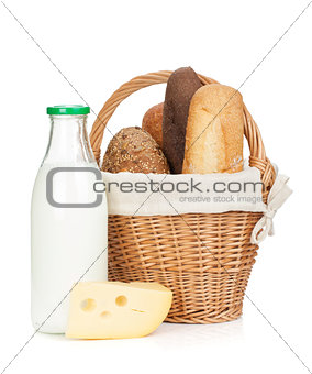 Picnic basket with bread, cheese and milk bottle