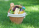 Outdoor picnic basket on green lawn