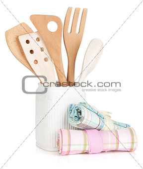 Kitchen utensils in holder and towels