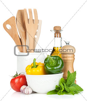 Fresh ripe vegetables, condiments and kitchen utensils