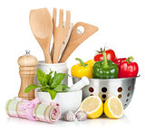 Fresh ripe vegetables, condiments and kitchen utensils