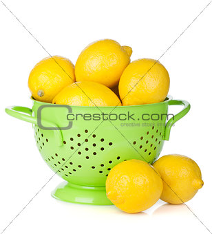 Fresh ripe lemons in colander