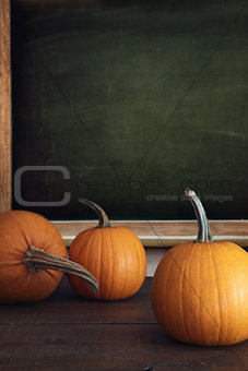 Pumpkins on table with menu board in background
