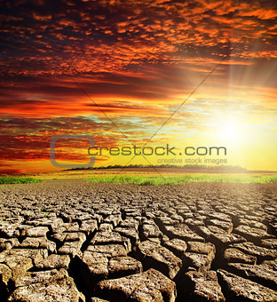 drought earth with red clouds and sunset