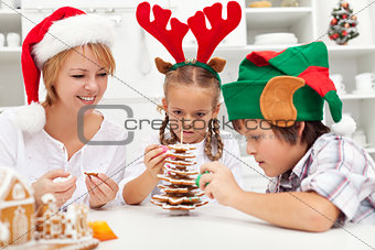 Happy family making a gingerbread cookie christmas tree