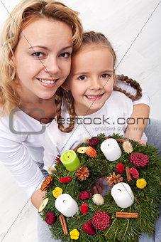 Woman and little girl with advent wreath