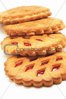 Cookies with red fruit jam on a white background
