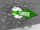 Arrow with word Teamwork breaking brick wall.