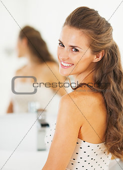 Portrait of smiling young woman in bathroom