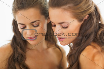 Portrait of young woman with reflection in the mirror