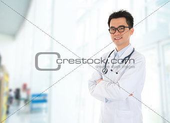 Asian doctor standing at hospital corridor