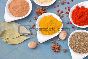 mix of spices on blue  table close up