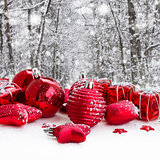 red christmas balls in snowed forest