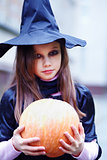 little witch with a pumpkin