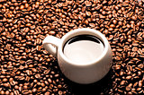 A cup of coffee on a background coffee grains