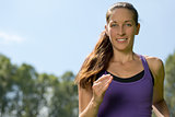 Young woman running outdoors training for marathon run