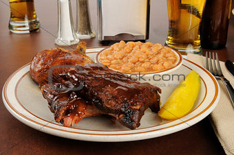 Barbecued ribs and chicken with baked beans