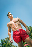 Young man in swimming shorts
