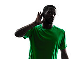 african man soccer player  silhouette hearing gesture 