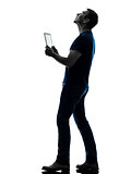 man holding digital tablet  looking up silhouette