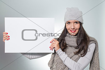 Smiling woman holding a blank sign