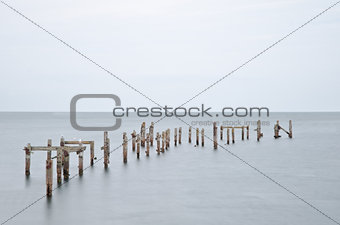 Long exposure derelict pier in calm sea