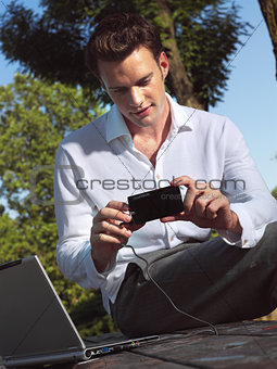 man with camera and laptop e