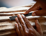 Hands woodcarver with the tool close-up