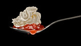 Strawberry jam and cream on spoon 