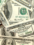 Money background from hundred bucks banknotes with magnifying gl