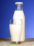 Bottle with fresh milk and glass on the table