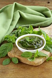 pesto sauce with basil and olive oil on a wooden table