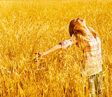 Happy woman on wheat field