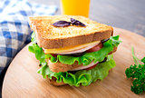 Sandwich with ham, cheese, tomatoes and lettuce