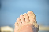 Woman's foot with sand