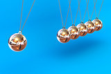 Newtons Cradle on a Blue Background
