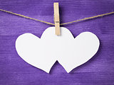 two paper hearts hanging on rope