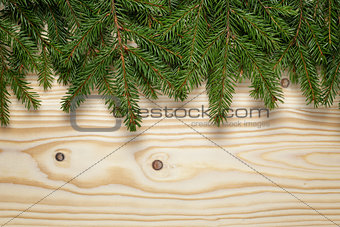 christmas background from fir twigs on wooden table