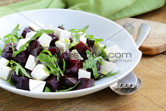 salad with beetroot and soft feta cheese and arugula