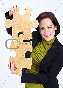 Woman Working With Two Large Jigsaw Puzzle Pieces