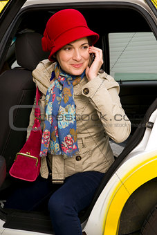 Woman Prepared for Winter exits a Taxi Talking on Cell Phone