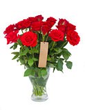 bouquet  of scarlet roses in vase with tag