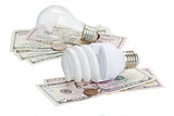 energy saving and normal   bulbs on dollars