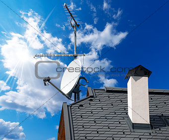Satellite Dish and Antenna TV on Blue Sky