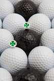 White and black golf balls and wooden tees