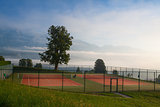 Tennis courts in the morning mist