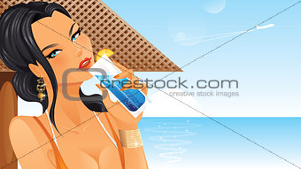 Beautiful woman drinking cocktail on beach