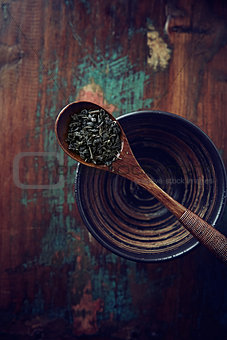 Green tea leaves (gun powder) on a wooden tea spoon