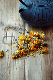 Dried Marigold Flowers and a cast iron tea pot
